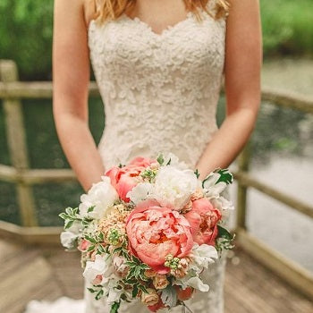 Bride In Lace Dress With Coral Bouquet