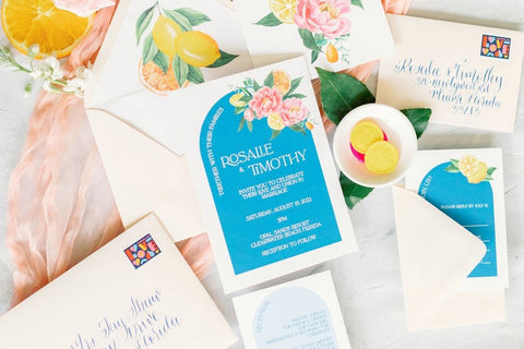 citrus destination wedding invitations with blue arches and watercolor lemons and flowers 