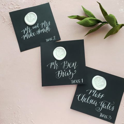 black-tie wedding calligraphy place cards with white wax seal by orlando wedding invitation designer fioribelle