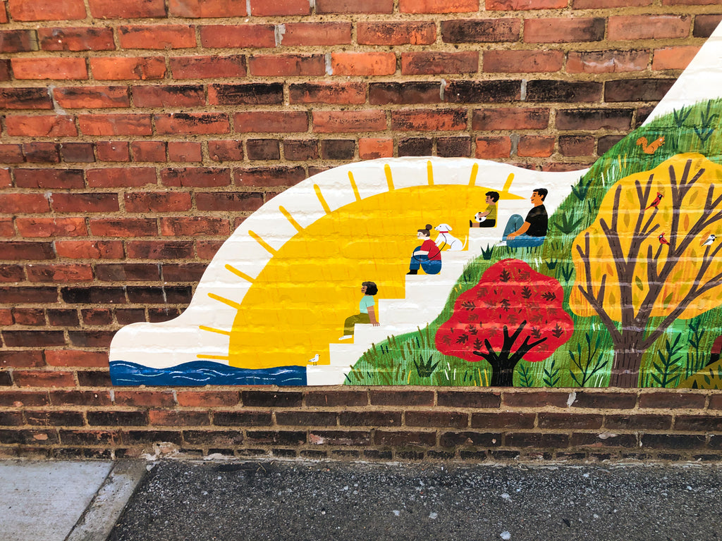 Section of mural with trees and people sitting on the Solstice Steps