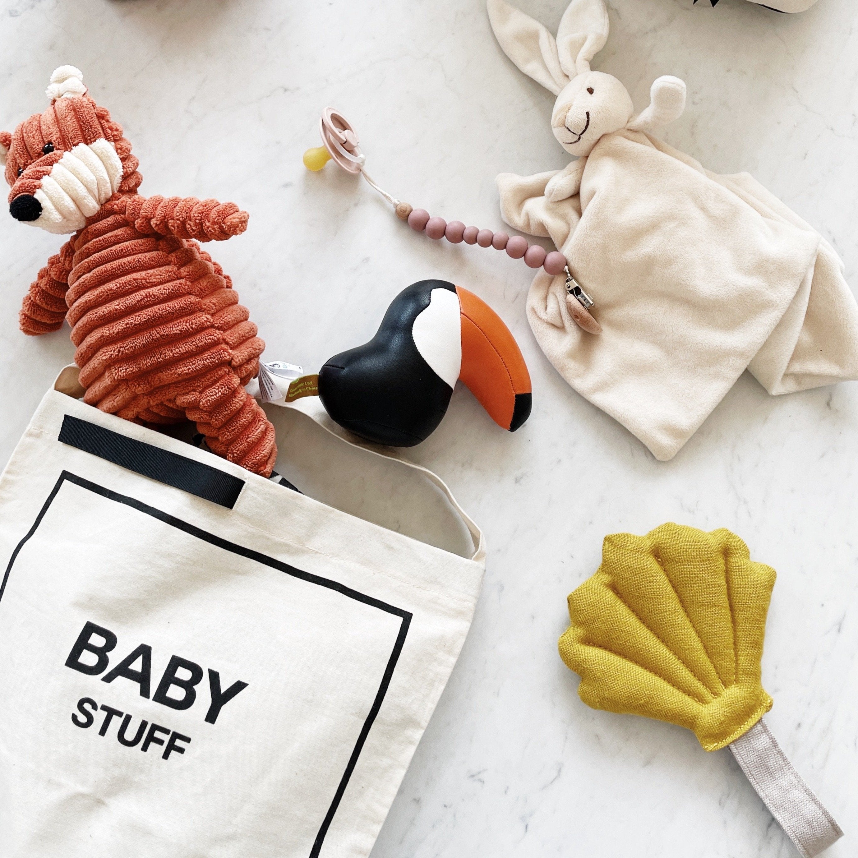 Toys and stuffed animals inside the baby bag couture.