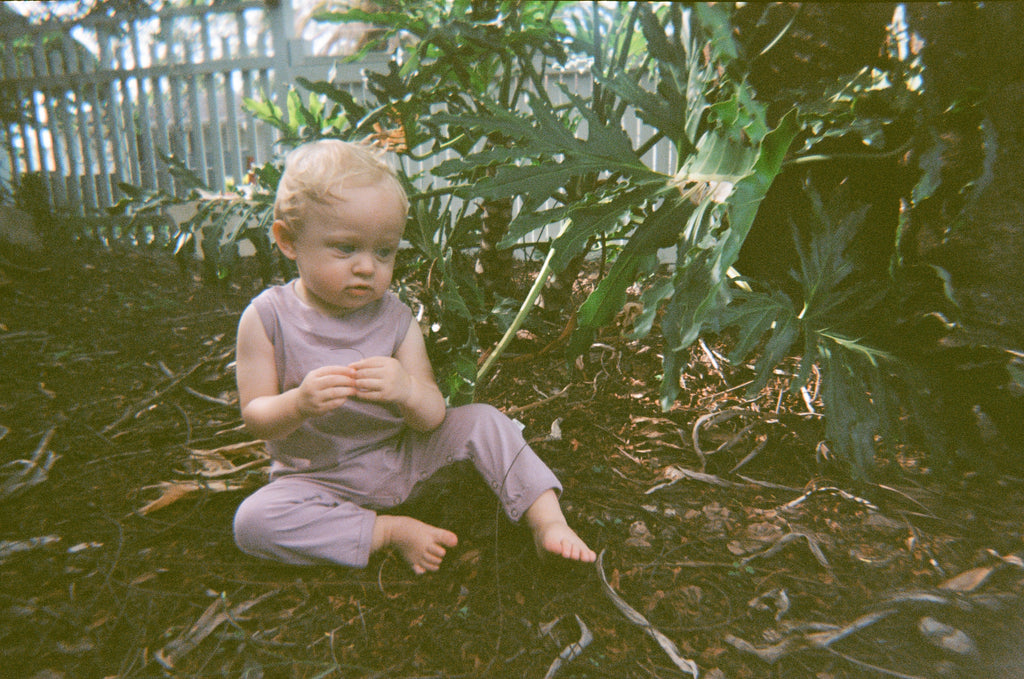 Albie wears the Romper in Lilac