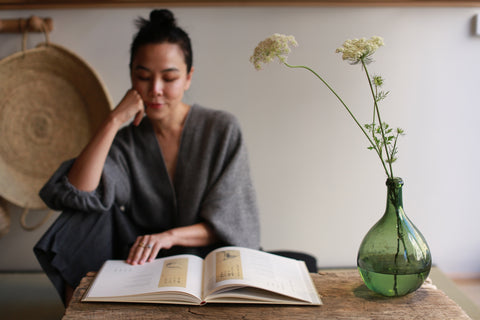 Designer Lan Jaenicke seated reading a book