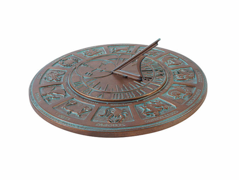 An old copper colored sundial clock with green patina.