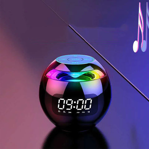 A ball shaped bedside electronic alarm clock which reads 9:00am. There are touch buttons on top and colors throughout the top half of the sphere.