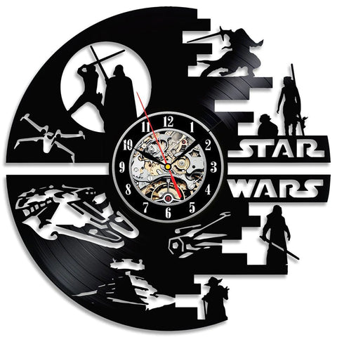 A Star Wars wall clock hanging on a greyish white brick wall.. The clock itself is a black vinyl record, and carved out of one side are silhouettes from the Star Wars world. The time reads 10:10am