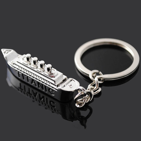 A silver colored Titanic keyring with the word 'Titanic' printed on the side of the keyring.