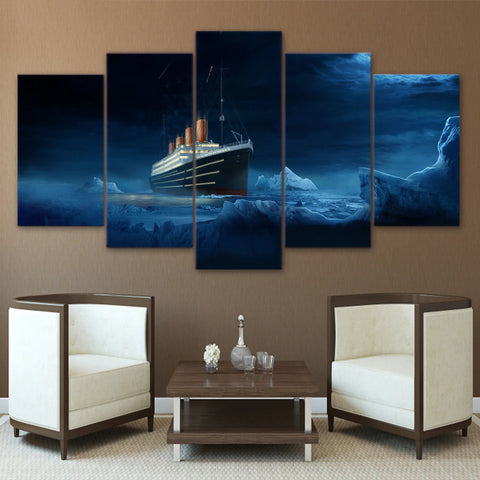 A five piece canvas set which features an image of Titanic. The canvas set is hung up on a wall with 2 chairs in front of it.