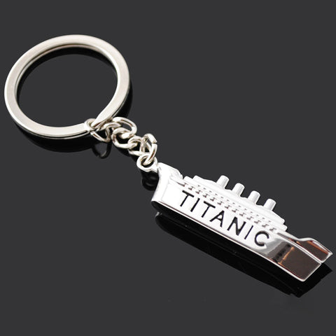 A silver colored Titanic keyring with the word 'Titanic' printed on the side of the keyring.