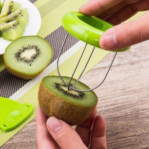 A hand using a kiwi fruit cutter to slice an already open kiwi fruit. 