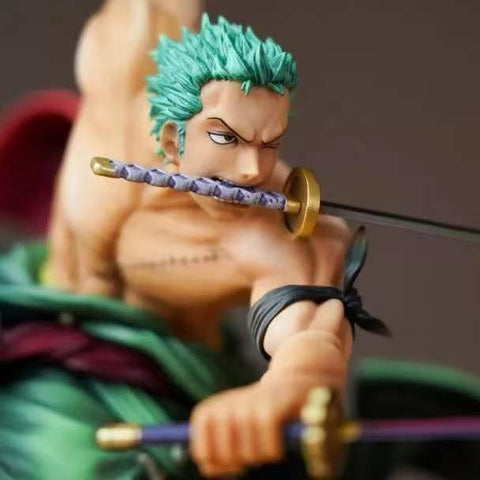 A closeup view of a Roronoa Zoro figurine in an action pose with his sword in his mouth.