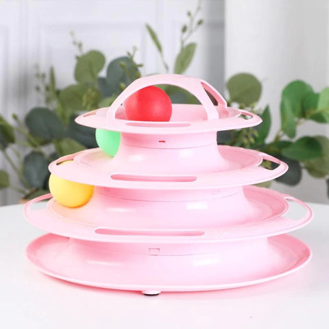 A pink colored multi level cat ball spinner toy which cats can interact with as they chase the ball around.