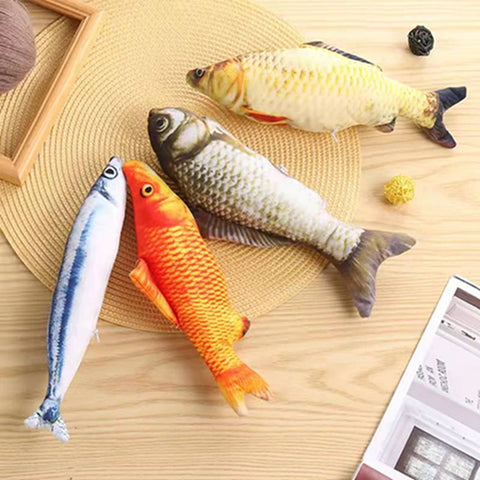 Four different coloured cat toys which are shaped like real fish, they also look very realistic.