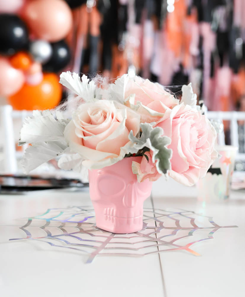 How Sweet Catherina Loves Petals Halloween Spooktacular flower rose arrangements in pink skull vases - A Little Confetti Party Blog