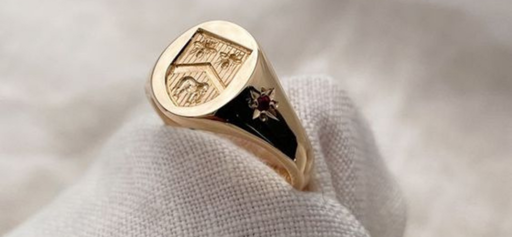 A hand engraved crest on a gold signet ring