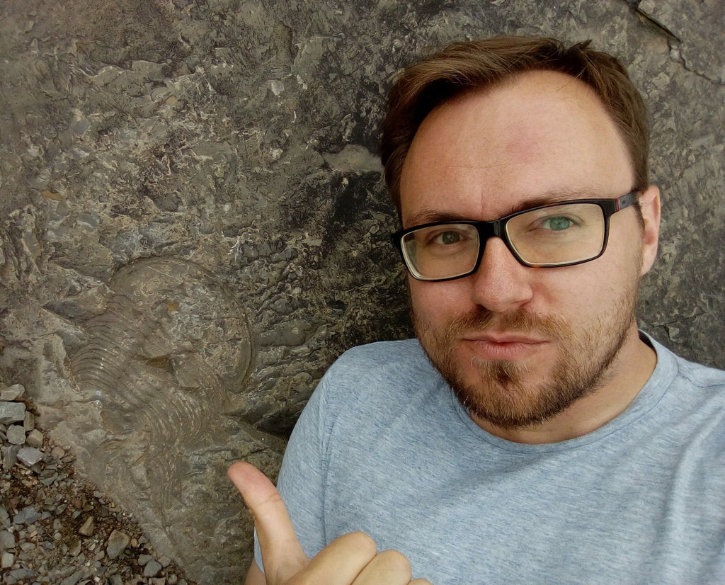 Lukas Laibl poses with Wanneria trilobite, Gros Morne National Park, Newfoundland. 