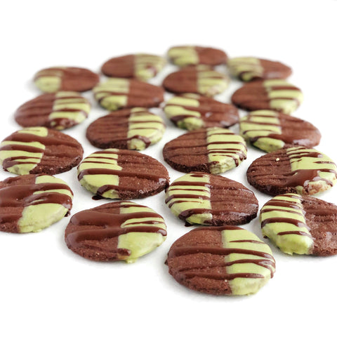 A tray full of JOYA's Matcha Mint Chocolate Cookies drizzled with chocolate