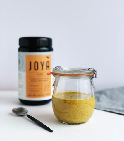 Image of JOYÀ rice pudding in small jar flavored with Glow Turmeric elixir blend