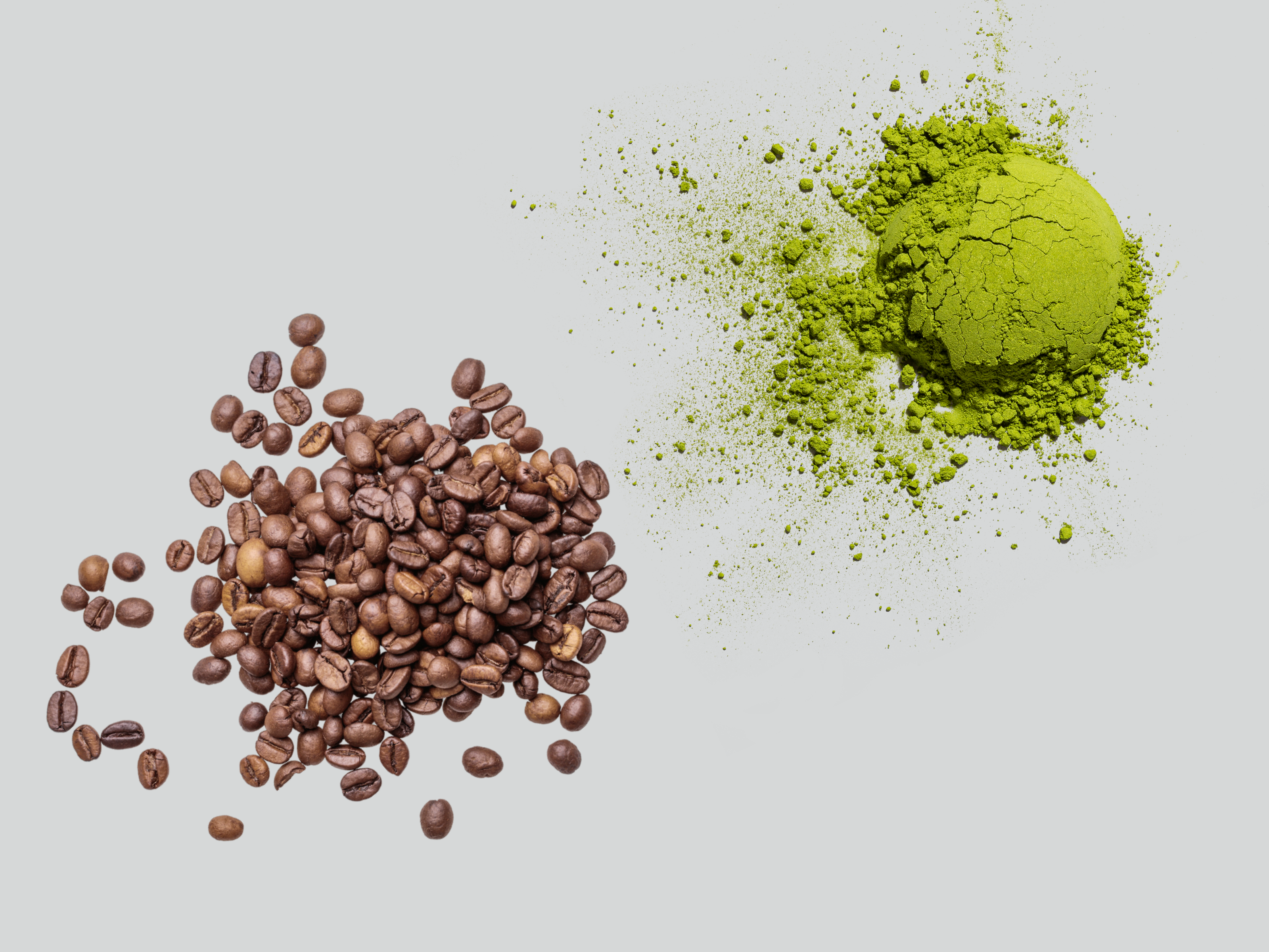 Overhead shot of a pile of coffee beans and matcha powder