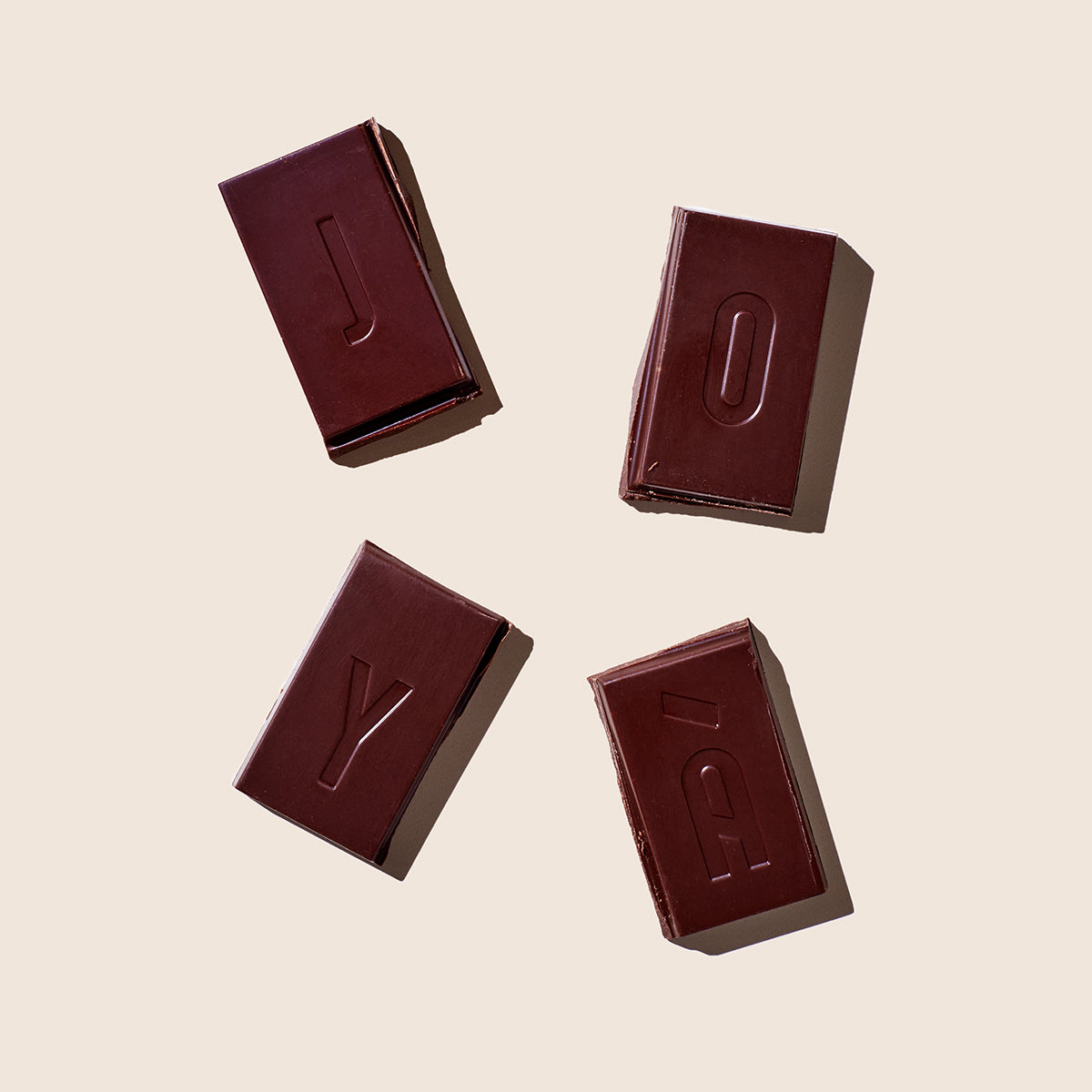 Overhead image of four squares of JOYÀ's Functional Chocolate