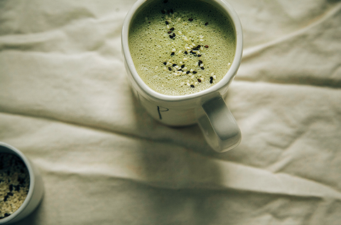 matcha in white coffee mug on wrinkled linen