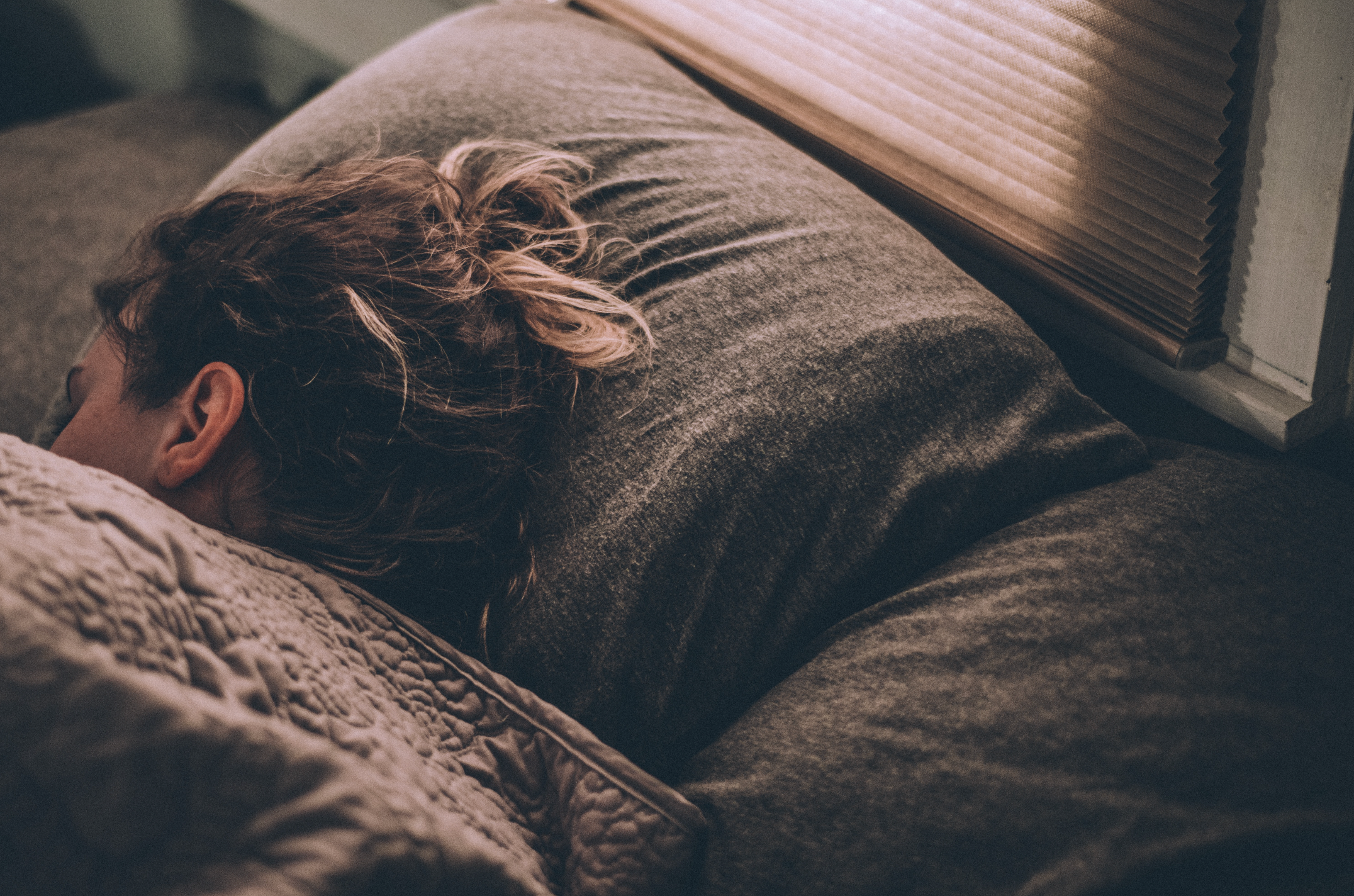 Young woman sleeping in bed