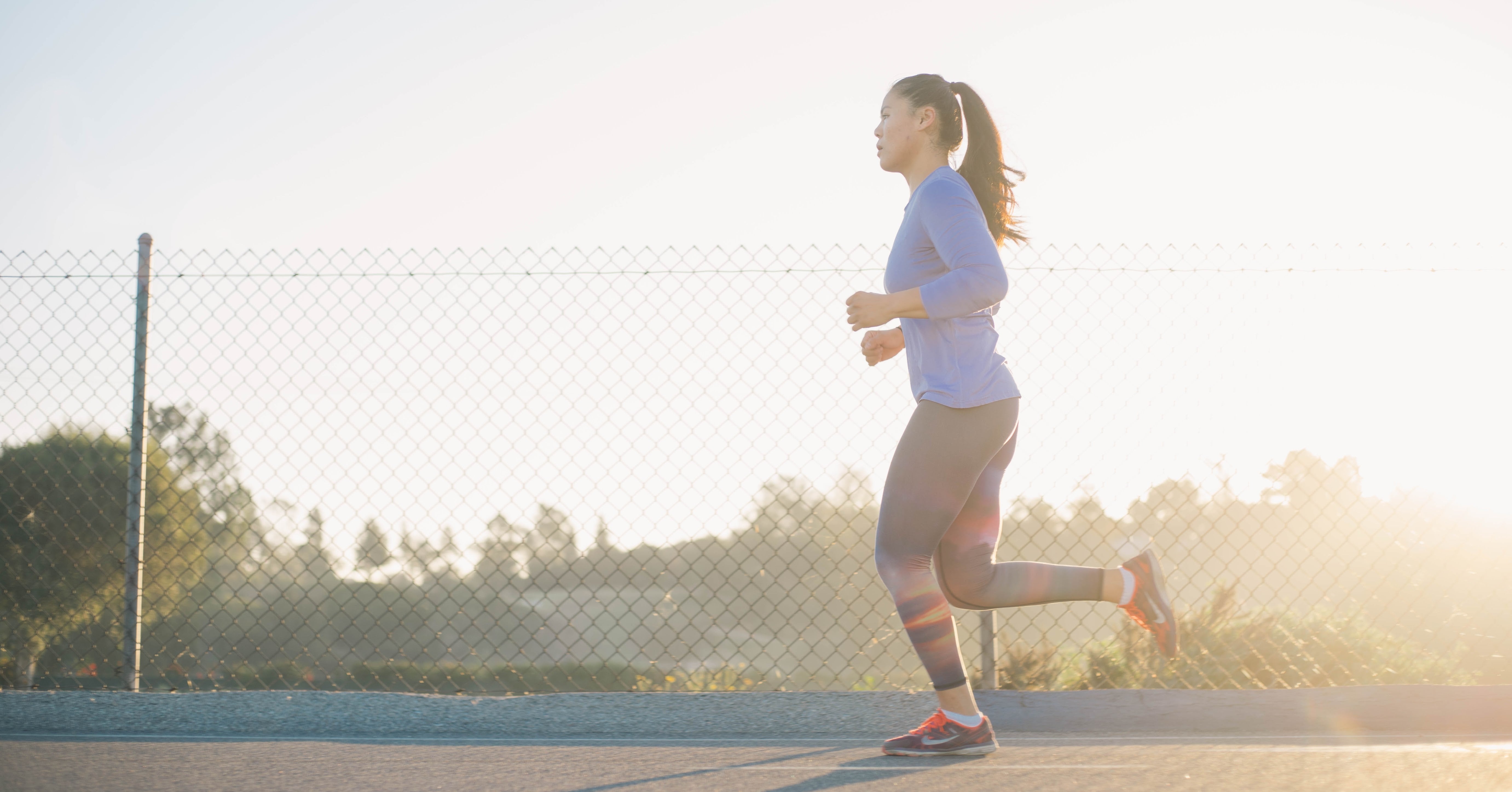 Woman with ponytail jogging outside