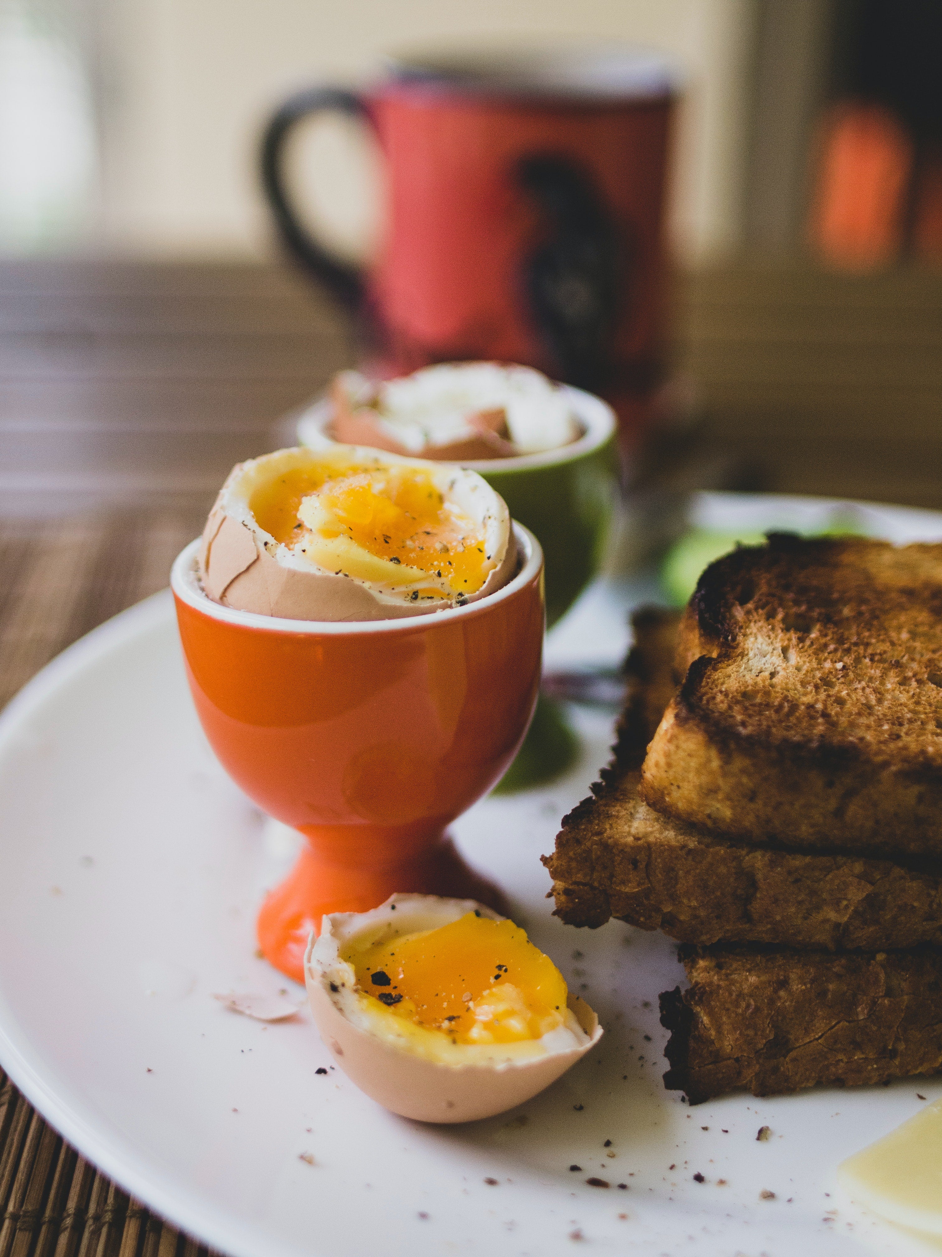 Soft boiled egg in egg cup with toast