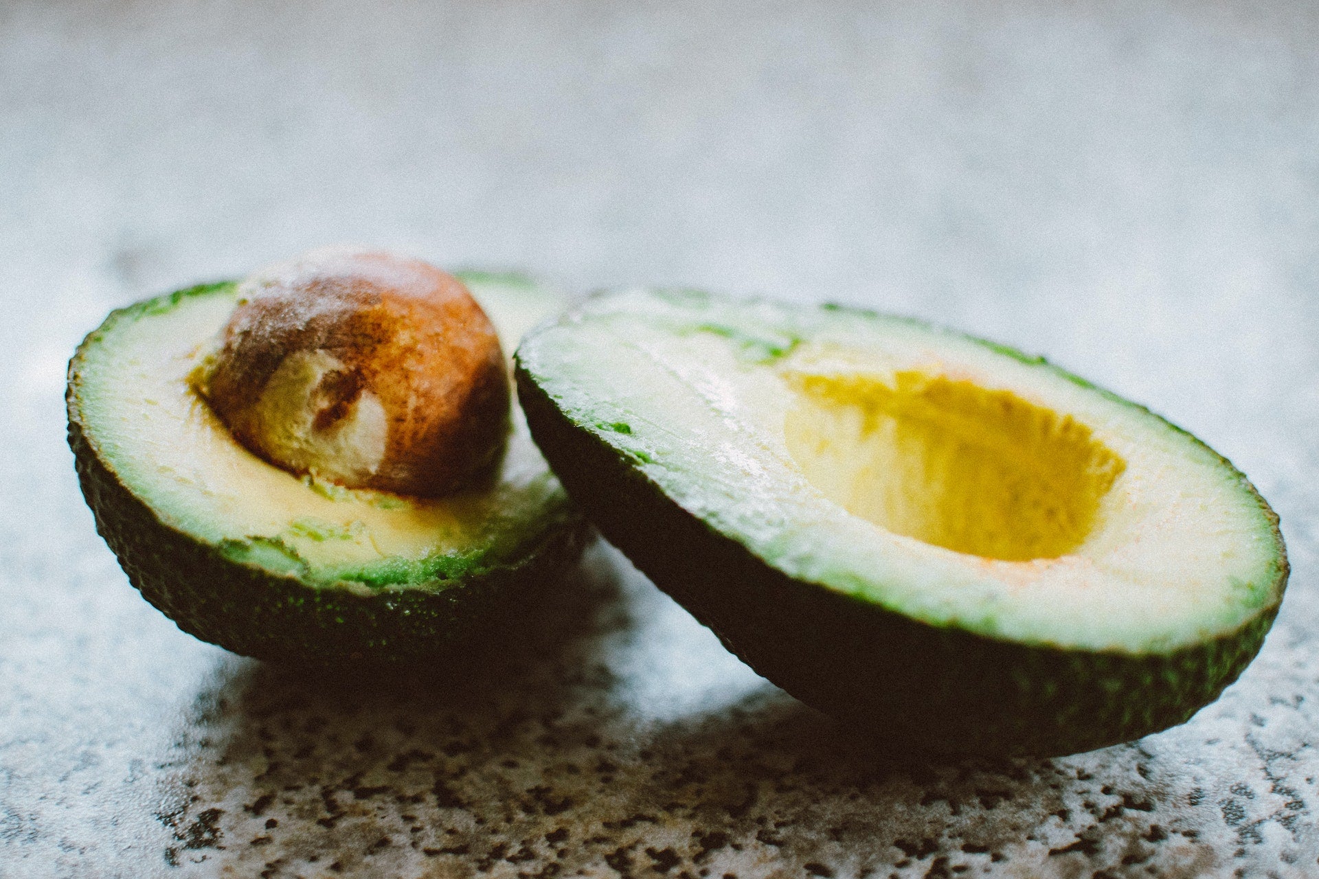 Two halves of a perfectly ripe avocado