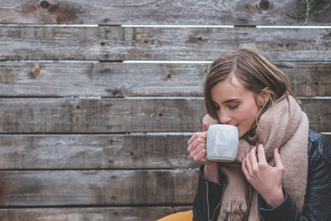 Woman enjoying a hot cup of coffee