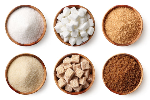 Overhead shot of six different types of sugar