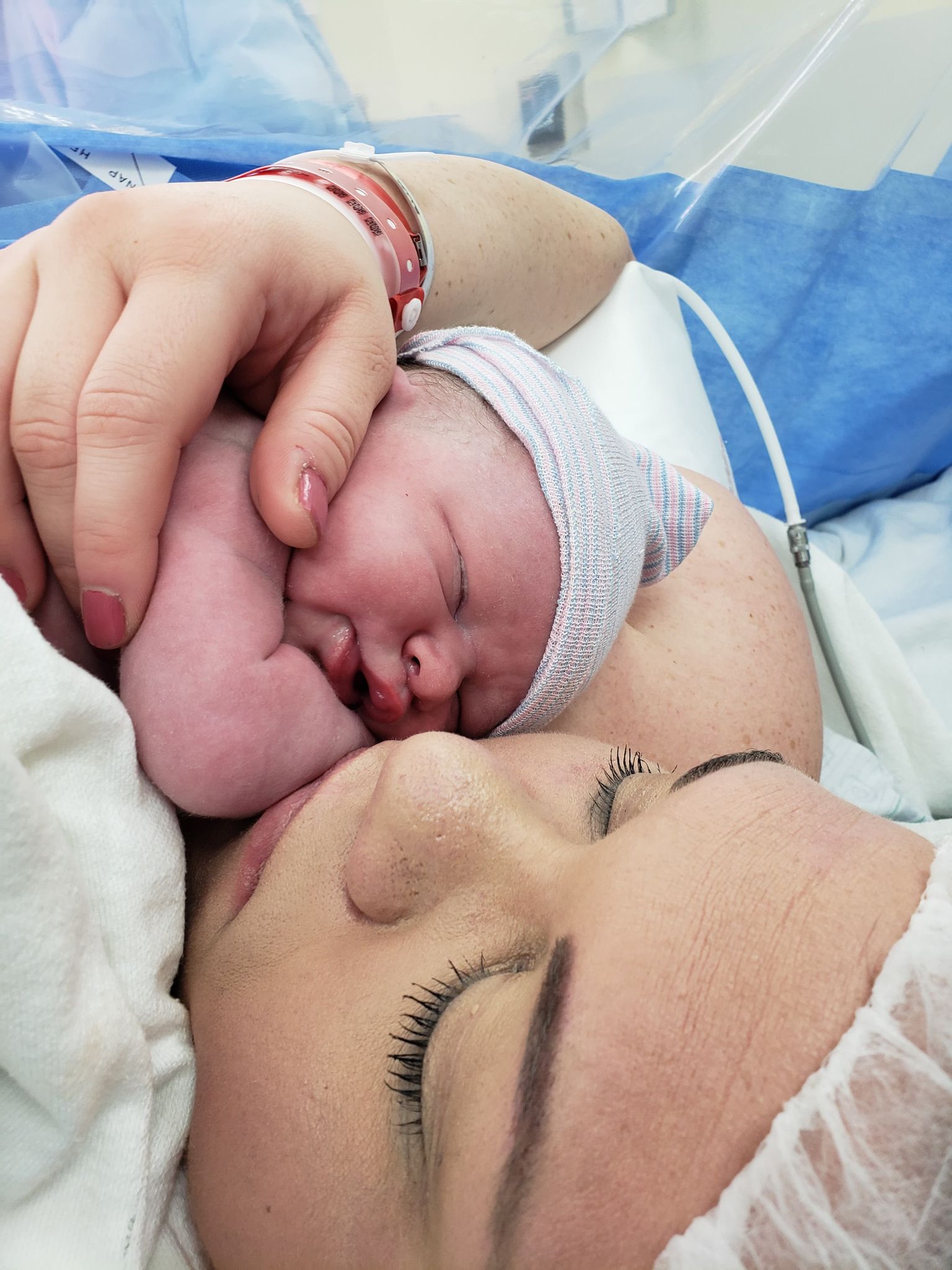 Newborn baby sleeping on mother's chest