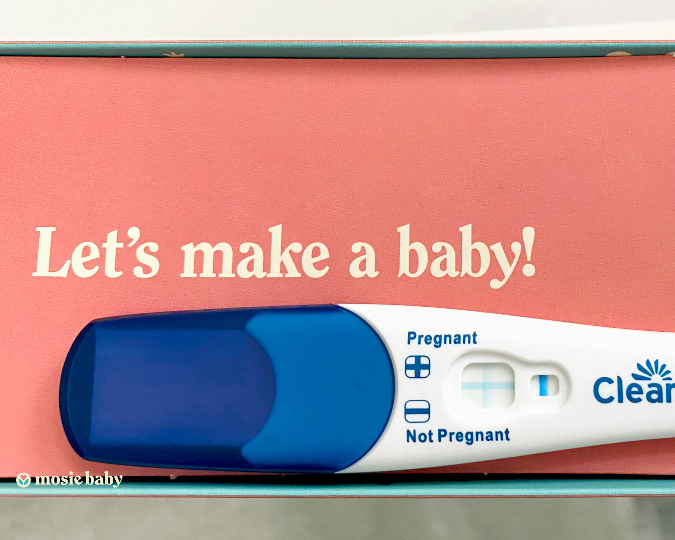 positive pregnancy test on top of a mosie baby box