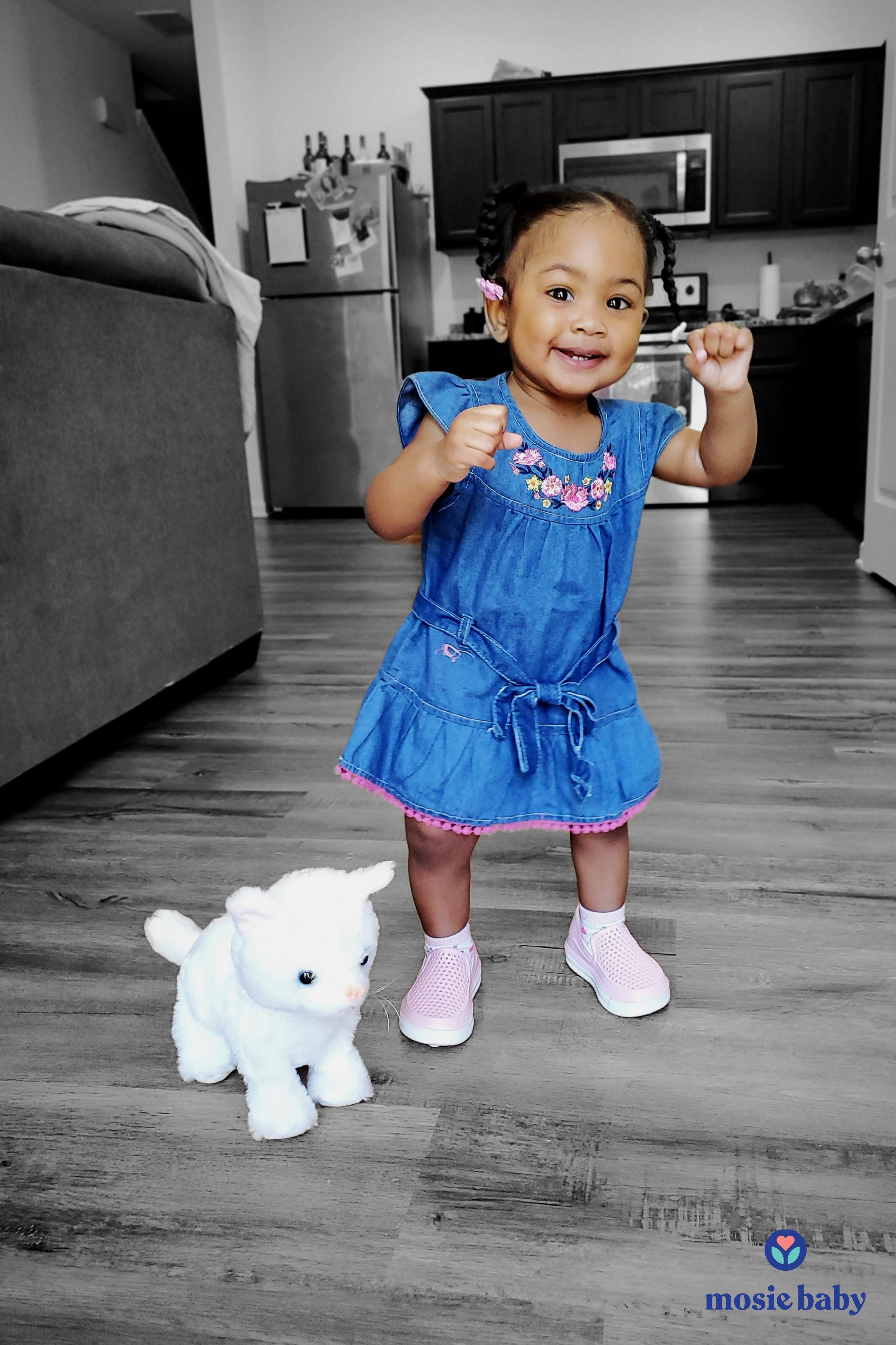 Young toddler standing with stuffed animal