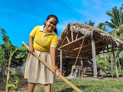 Filipino woman farms at a coconut farm
