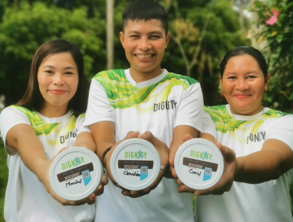 Employees Holding Jar of Coconut Oil