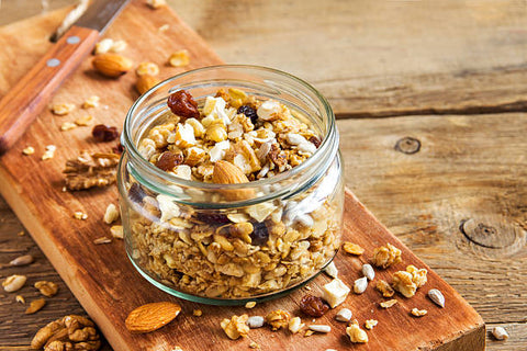 A glass jar is filled with granola
