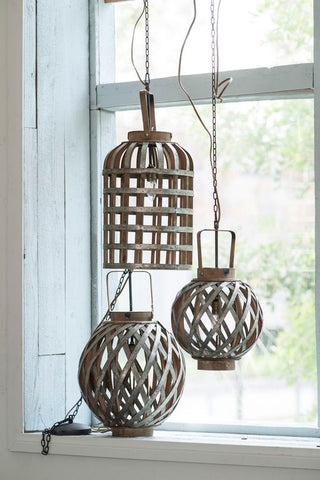 three hanging rattan lanterns by the window with natural sunlight.