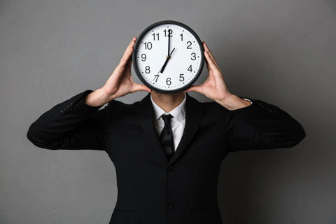 man holding clock