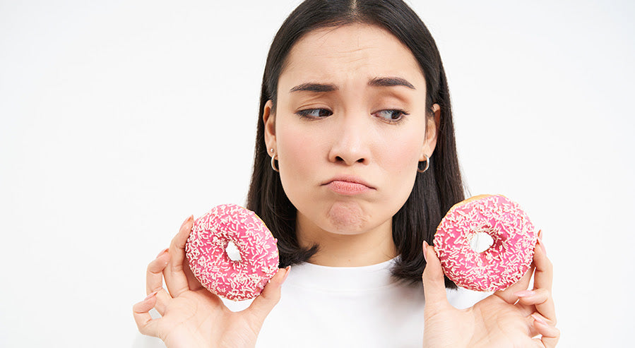 A Woman Holding Sugary Donuts