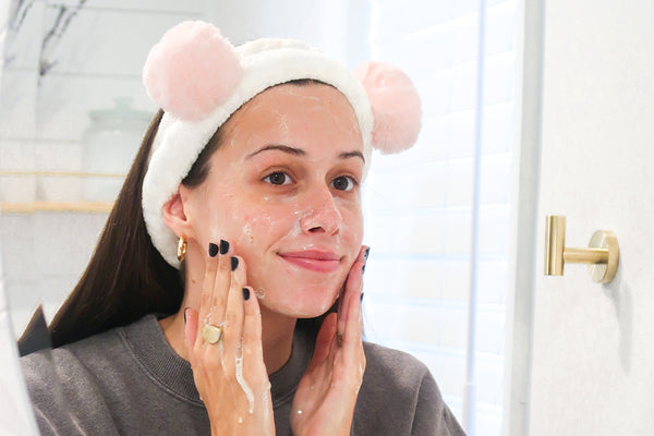 woman using Teami Green Tea Facial Cleanser