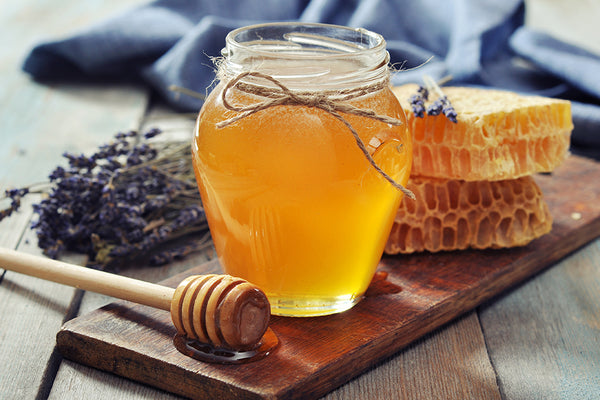 jar of honey with honey combs