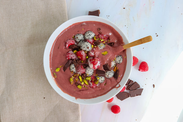 raspberry smoothie bowl with teami Organic Plant-Based Wellness Protein