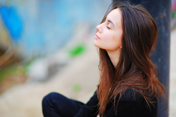 woman meditating and reciting her daily affirmations