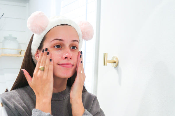 woman applying moisturizer