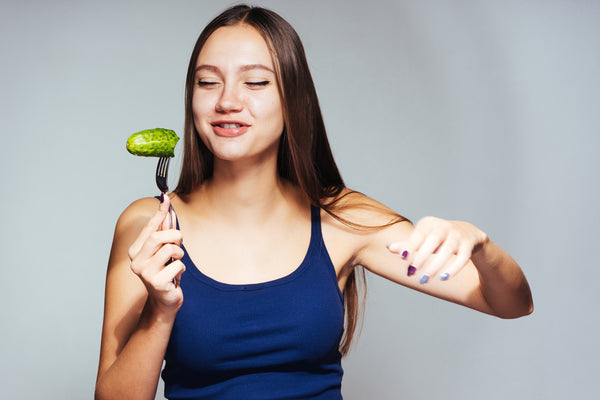 woman eating a pickle