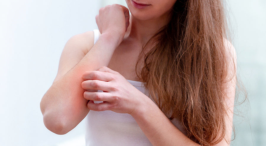 Woman Examining Skin Irritation