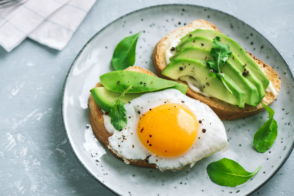 Avocado slices with a fried egg on toast