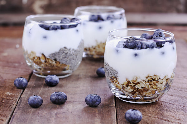 Cup of yogurt with granola with chia seeds, blueberries and granola