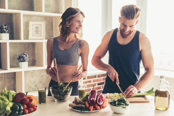 young couple preparing fresh vegetables for lunch